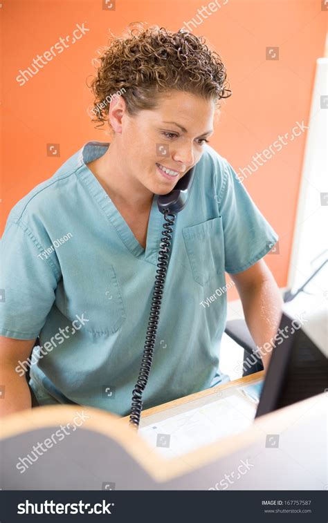 Female Nurse Answering Telephone While Working Stock Photo 167757587