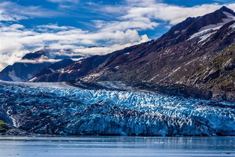 The Blue Ice Of Lamplugh Glacier Hugs The Coastline Of Alaskas Glacier