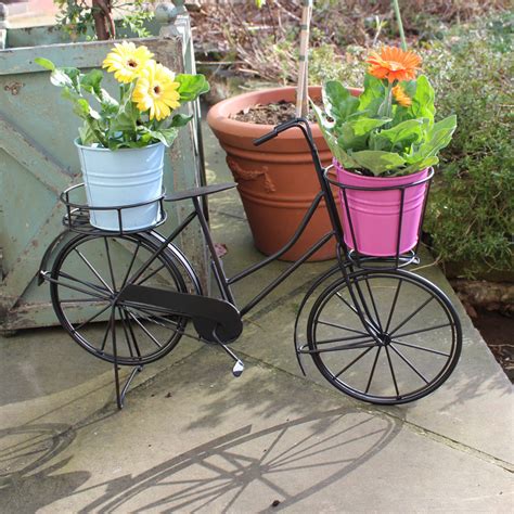 By turning the bike's front basket and rear pannier baskets into hanging baskets, you can create a fanciful shabby chic display. Black Rustic Bicycle Plant Holder - Melody Maison®