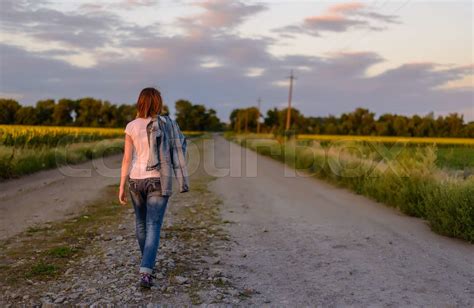 Woman Walking Down A Country Road Stock Image Colourbox
