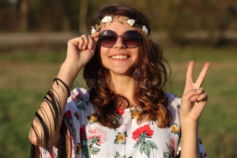 Happy Young Girl Hippie Smiles And Showing Sign Of Peace Outdoors Stock