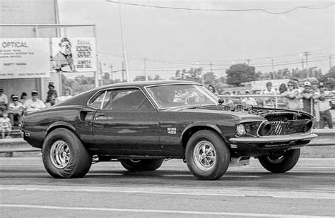 A Black And White Photo Of An Old Muscle Car