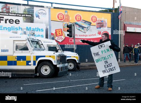 belfast uk 12 01 13 a man holding a placard shouts at police as rioting breaks in the belfast