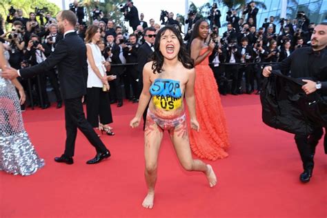 At The Premiere Of Cannes A Topless Protestor Shatters The Red Carpet