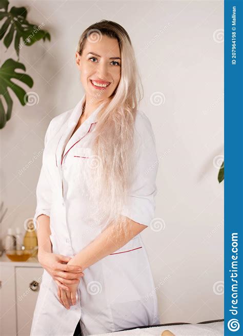 Woman With Blond Hair In A Medical Gown Stock Photo Image Of Massage