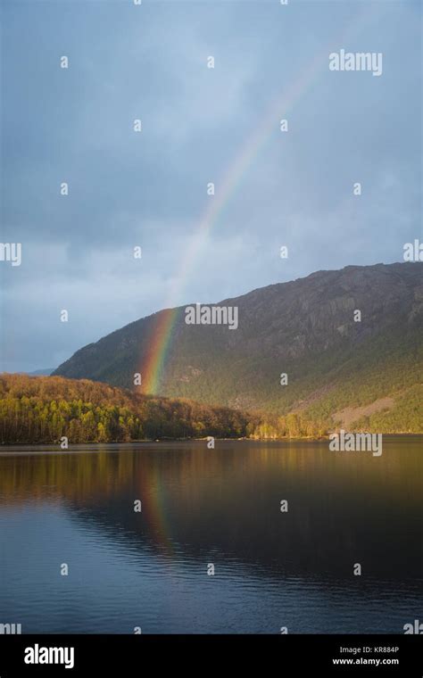 A Rainbow Over A Lake And Rolling Hills In Norway Stock Photo Alamy
