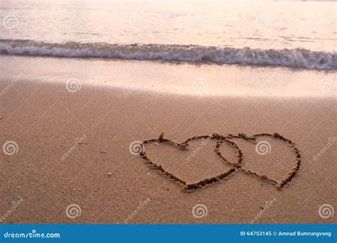 Two Hearts Drawn On Sand Of A Tropical Beach At Sunset Royalty Free
