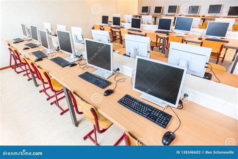 Computer Class With Rows Of Desktop Computers In School Stock Photo