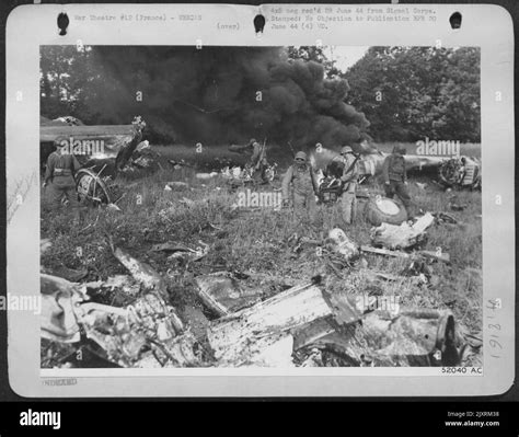 American troops search the burning wreckage of a crashed liberator for