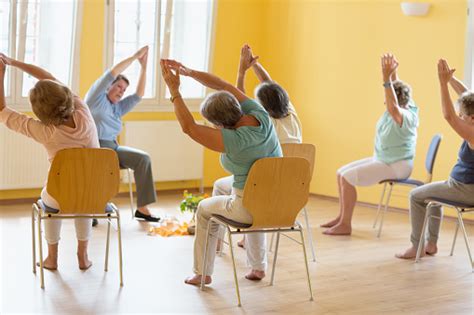 Active Senior Women Yoga Class On Chairs Stock Photo Download Image