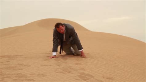 Exhausted Businessman Crawling In The Desert Stock Footage Video