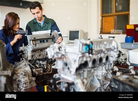Serious Trainee And Instructor Repairing An Engine Stock Photo Alamy