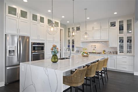White Cabinet Kitchen With Stainless Appliances And Large Center Island