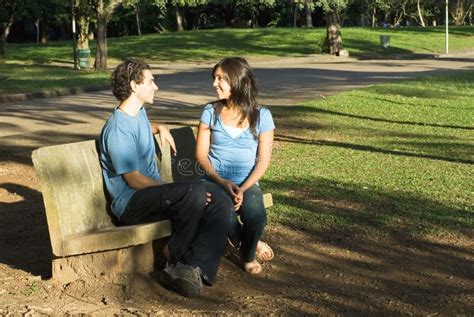Couple Talking On A Park Bench Horizontal Stock Photography Image