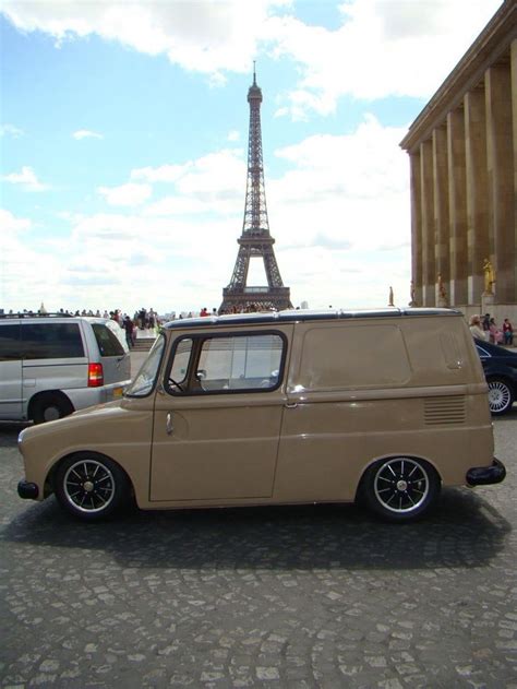 An Old Van Parked In Front Of The Eiffel Tower