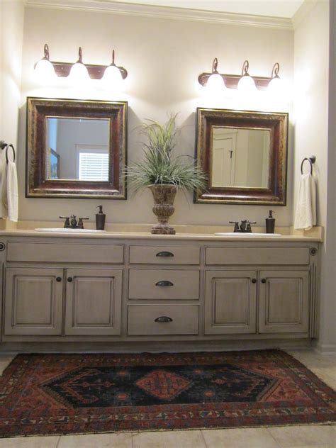 A quick and easy way to change the design of your bathroom, vanities can be as simple or as elegant as you desire. Love these painted bathroom cabinets and the lights. What ...