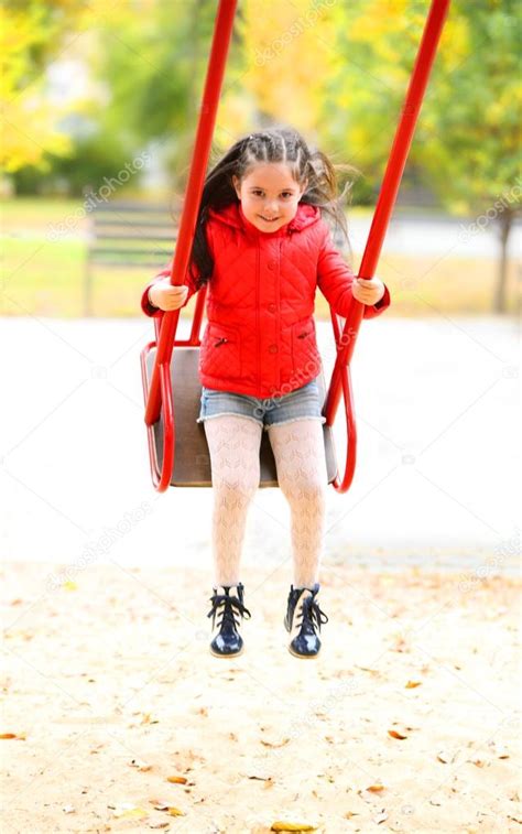 Little Girl On Swing In City Park — Stock Photo © Belchonock 89545026