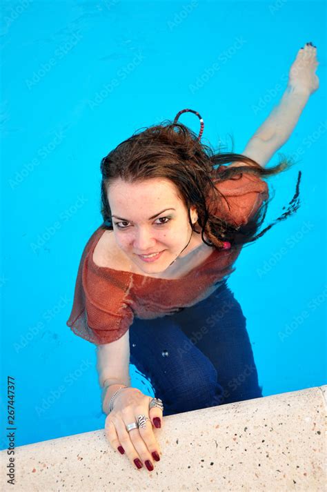 Fully Dressed Girl Swimming In The Pool Wearing Her Wet Clothes On On A Hot Summer Day Foto De