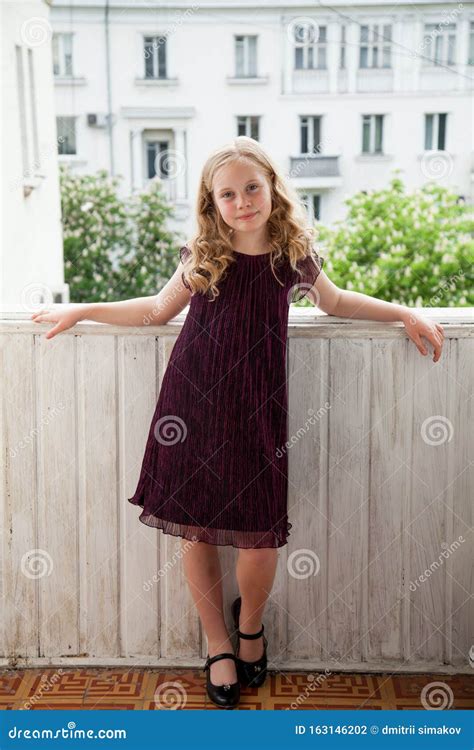 Portrait Of A Beautiful Girl 10 Years Old In A Dark Dress Stock Photo