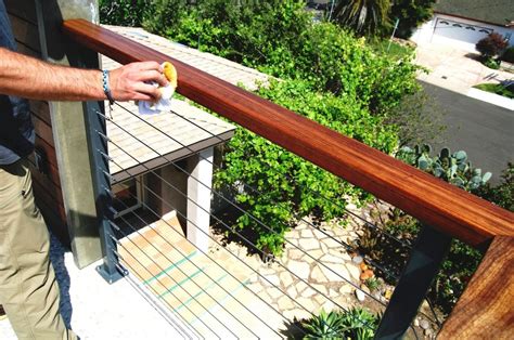 The railing has two posts that it is attached to with a floral and leaf decorative piece that is attached to each of the posts. Do It Yourself Cable Railings Archives - San Diego Cable Railings | Cable railing, Stainless ...