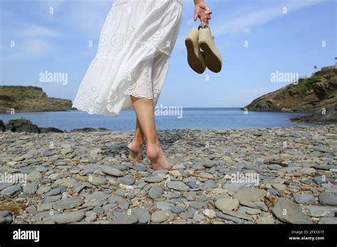 Back View Portrait Of Barefoot Woman Legs Holding Shoes Walking On The