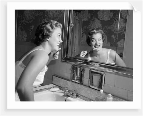 1950s Smiling Woman Looking Into Bathroom Mirror Brushing Teeth Posters And Prints By Corbis