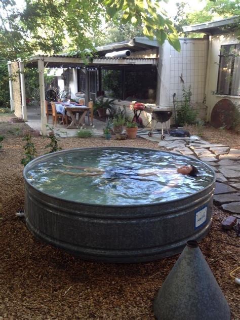 Take two or three of these galvanized stock tanks that have rounded edges and oval shapes and display them on the porch or along your house. Soaking tub | Stock tank swimming pool, Tank swimming pool