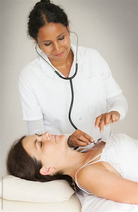 Female Doctor Examining Patient With Stethoscope By Visualspectrum