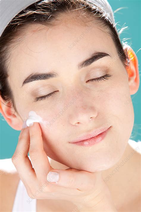 woman applying cream stock image c032 5871 science photo library