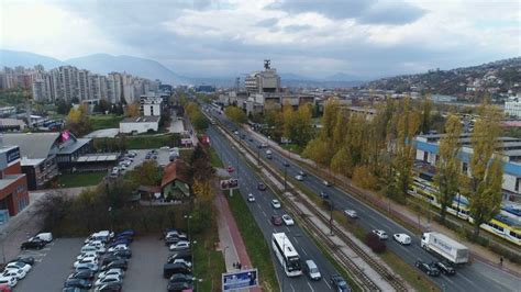 An Aerial View Of A City Street With Cars Parked On The Side And