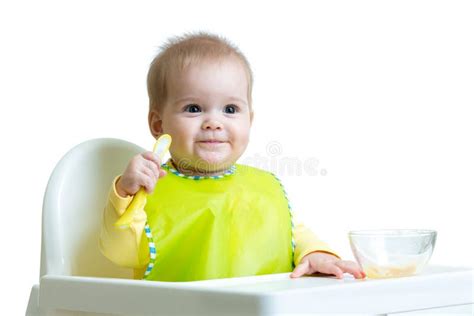 Happy Baby Child Sitting In Chair With A Spoon Stock Photo Image Of