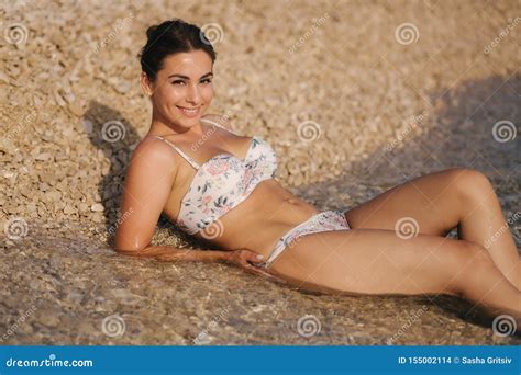 Woman In Bikini On The Beach Enjoying Summer Sun Beautiful Woman Lies Near The Sea Stock Photo