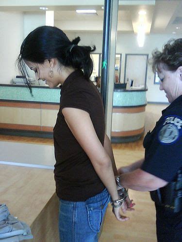Young Woman Smiles While She Gets Handcuffed Behind Back At A Polices Open Day Woman Smile