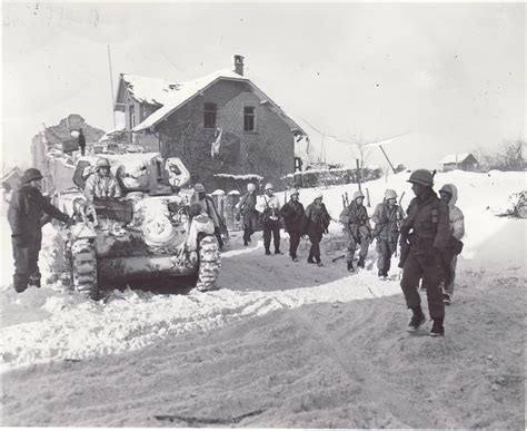 Parachute Infantrymen Pass An M5a1 Light Tank Of 7 Armored Division