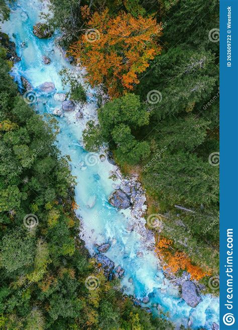 Aerial Top View Of The Soca River Flowing Through A Forest In Slovenia