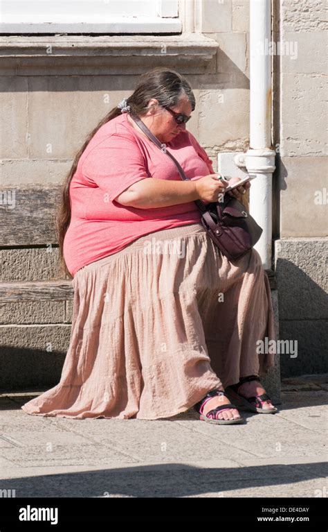 Obese Woman Sitting In The Sunshine Okehampton Devon Stock Photo Alamy