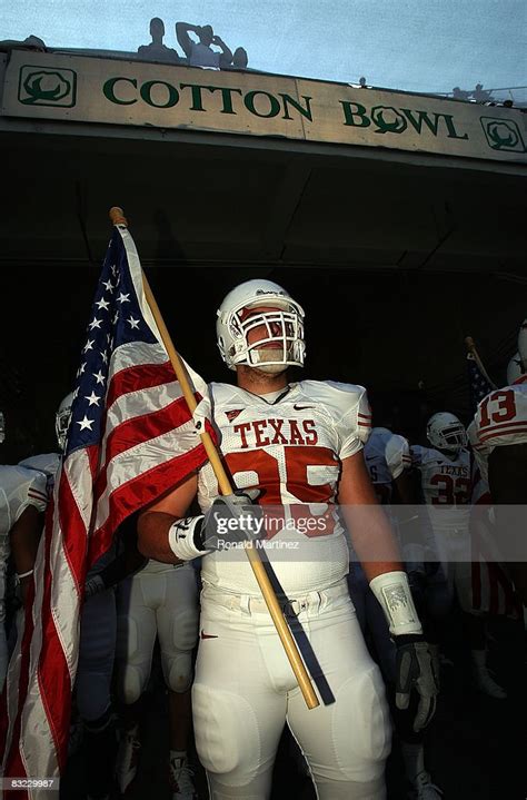 Defensive End Aaron Lewis The Texas Longhorns Carries A Flag As He