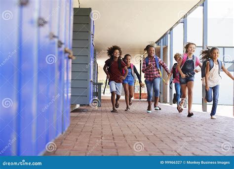 School Kids Running To Camera In Elementary School Hallway Stock Image