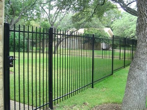 Ornate wrought iron and stone slate entry gate. Beautiful Wrought Iron Fence Designs