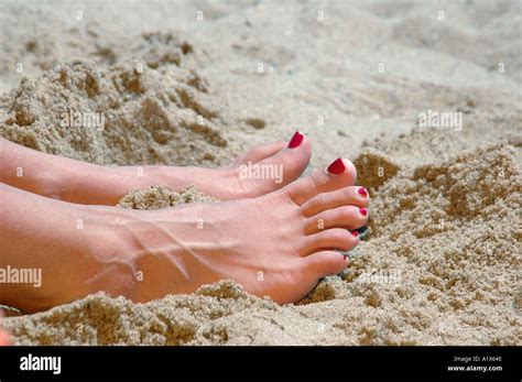 Woman With Feet In Sand Bright Sun On Beach Vacation Stock Photo Alamy