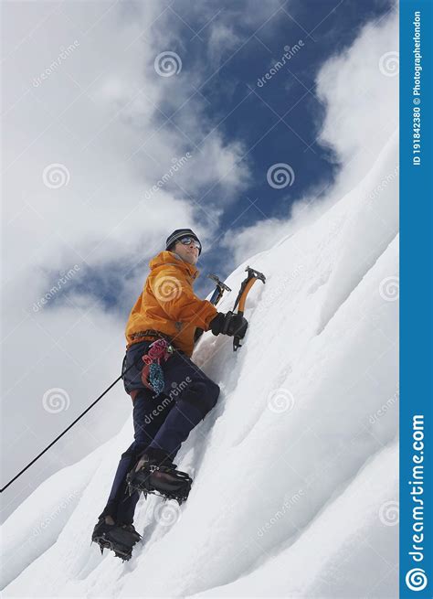 Mountain Climber Going Up Snowy Slope With Axes Stock Photo Image Of