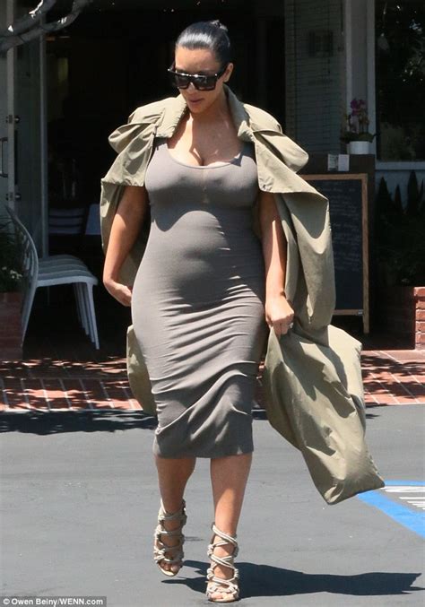 Kim Kardashian Shows Off Her Figure In Dress And Open Trench Coat