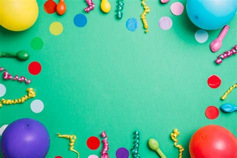 Birthday Party Items On Green Background With Colorful Confetti Photo