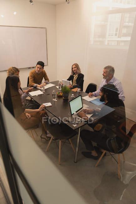 Executives Discussing In Meeting Room At Office — Business