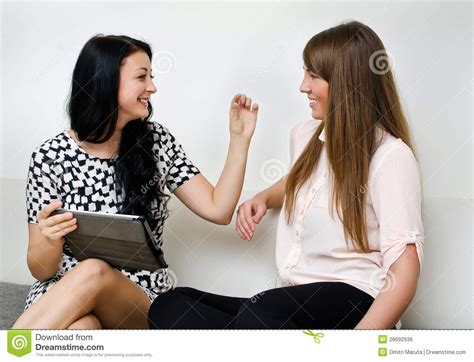 Two young women chatting stock photo. Image of equipment - 26692936