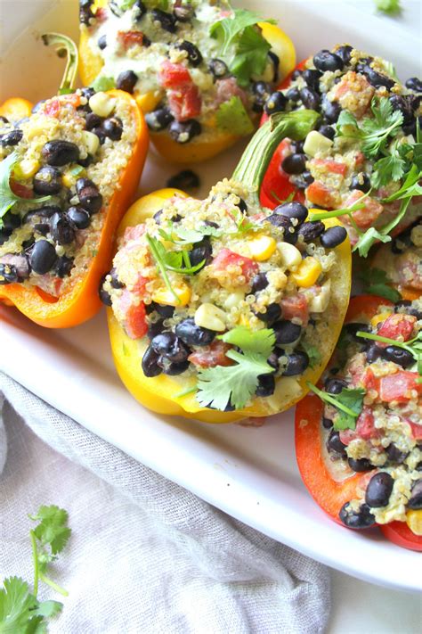 stuffed bell peppers with black beans tomatoes and avocado garnished with cilantro