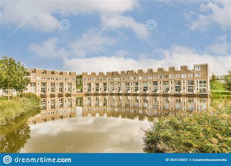 A Large Building Reflected In A Body Of Water Stock Image Image Of