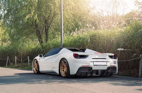The car has a white stripe with two yellow pinstripes on either side and ferrari shields on the front fenders. White Ferrari 488 GTB - ADV05 M.V2 CS Series Wheels - ADV.1 Wheels
