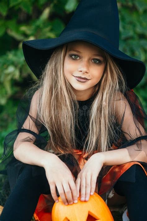 Halloween Little Girls In Witch Costume Out For Trick Or Treating Stock