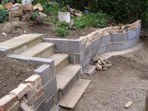 It is simple to make and quick to complete the project once you receive all the crucial preparation done. inexpensive wall- could even face the cinder blocks with stone in 2019 | Garden retaining wall ...